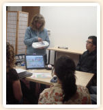 Instructor demonstrates communication devices for speech therapy students